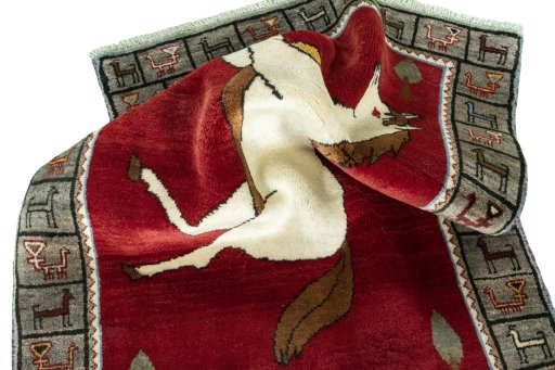 Corner detail of 2000s Persian Gabbeh rug showing border pattern and Wool pile