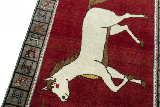 Backside of handmade 2000s Persian Gabbeh rug showing knot structure and weave density