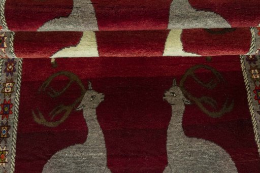 Full view of 2000s Persian Gabbeh rug from Iran / Persia, 235 × 110 cm in Red tones