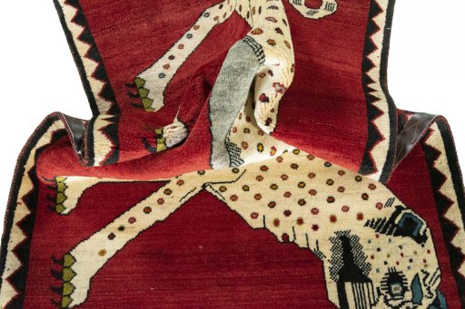 Corner detail of 2000s Persian Gabbeh rug showing border pattern and Wool pile