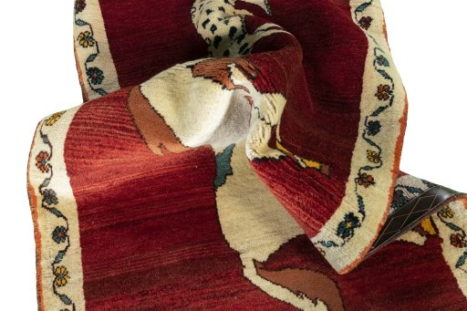 Corner detail of 2000s Persian Gabbeh rug showing border pattern and Wool pile