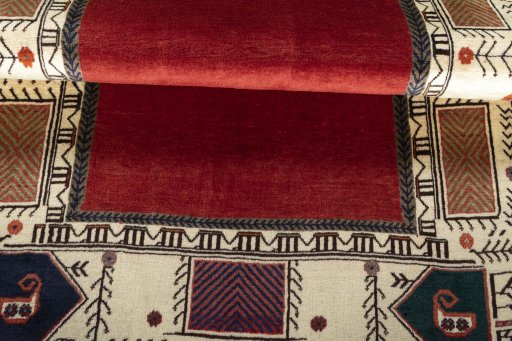 Corner detail of 2000s Persian Gabbeh rug showing border pattern and Wool pile
