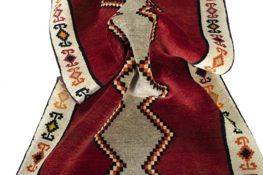 Corner detail of 2000s Persian Gabbeh rug showing border pattern and Wool pile