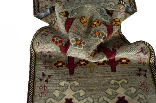 Corner detail of 2000s Persian Gabbeh rug showing border pattern and Wool pile