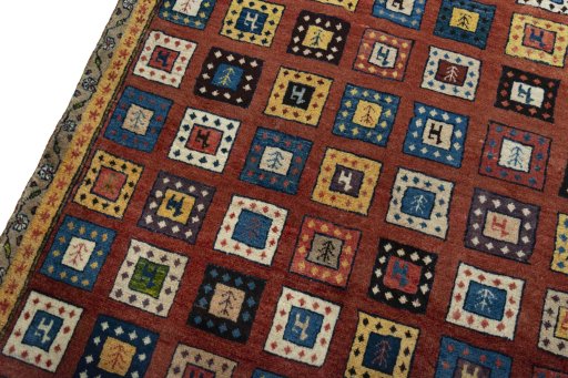 Backside of handmade 2000s Persian Gabbeh rug showing knot structure and weave density