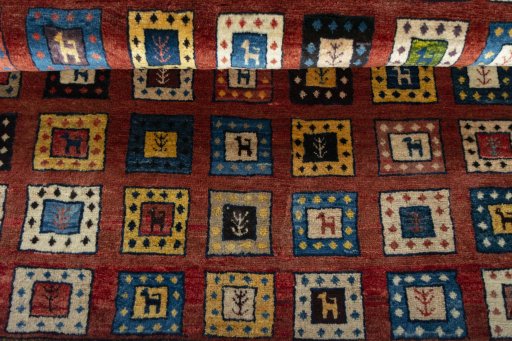 Full view of 2000s Persian Gabbeh rug from Iran / Persia, 133 × 102 cm in Red tones