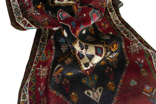 Corner detail of 2000s Persian Gabbeh rug showing border pattern and Wool pile