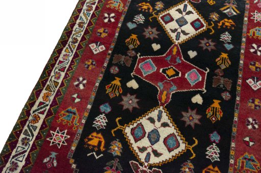 Backside of handmade 2000s Persian Gabbeh rug showing knot structure and weave density