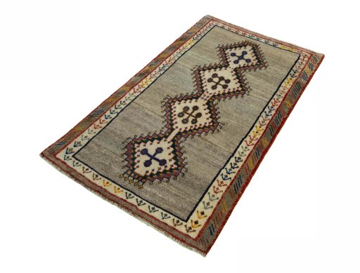 Corner detail of 2000s Persian Gabbeh rug showing border pattern and Wool pile