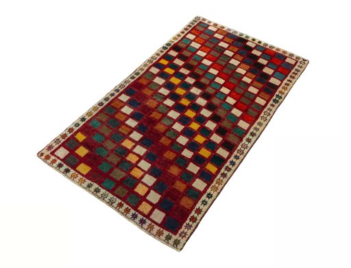 Corner detail of 2000s Persian Gabbeh rug showing border pattern and Wool pile