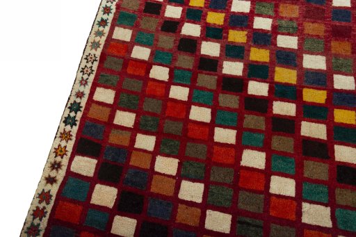 Backside of handmade 2000s Persian Gabbeh rug showing knot structure and weave density