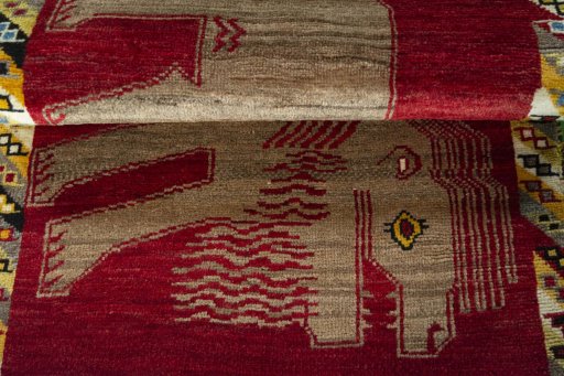 Full view of 2000s Persian Gabbeh rug from Iran / Persia, 131 × 82 cm in Red tones