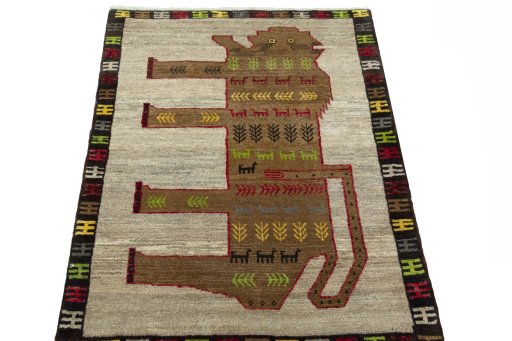 Surface texture of 2000s Persian Gabbeh rug with natural Wool and intricate pattern