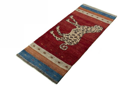 Corner detail of 2000s Persian Gabbeh rug showing border pattern and Wool pile