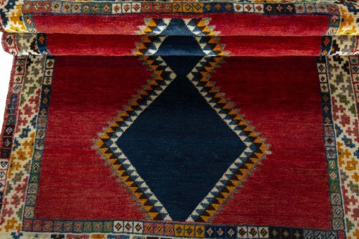 Full view of 2000s Persian Gabbeh rug from Iran / Persia, 150 × 102 cm in Red tones