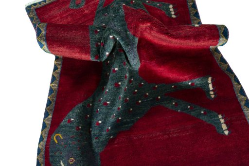 Corner detail of 2000s Persian Gabbeh rug showing border pattern and Wool pile