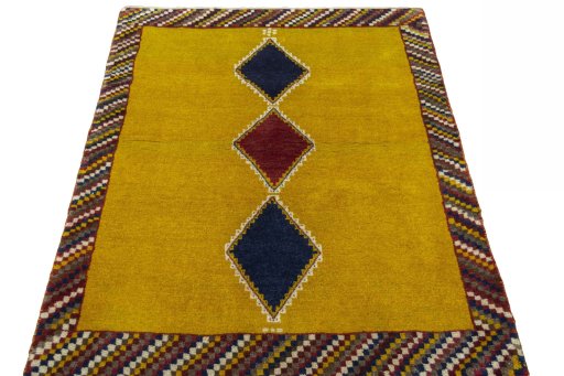 Surface texture of 2000s Persian Gabbeh rug with natural Wool and intricate pattern