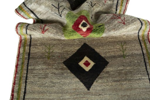 Corner detail of 2000s Persian Gabbeh rug showing border pattern and Wool pile