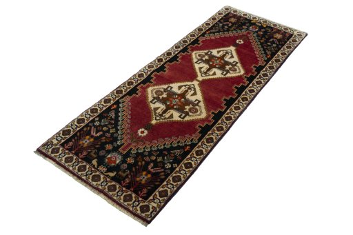 Corner detail of 2000s Persian Gabbeh rug showing border pattern and Wool pile