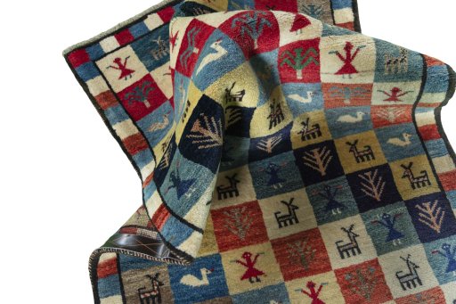 Corner detail of 2000s Persian Gabbeh rug showing border pattern and Wool pile