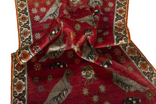 Corner detail of 2000s Persian Gabbeh rug showing border pattern and Wool pile