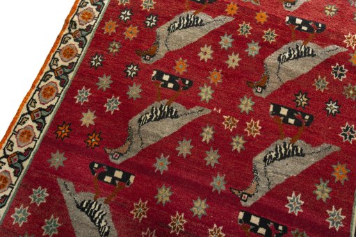 Backside of handmade 2000s Persian Gabbeh rug showing knot structure and weave density