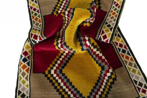 Corner detail of 2000s Persian Gabbeh rug showing border pattern and Wool pile