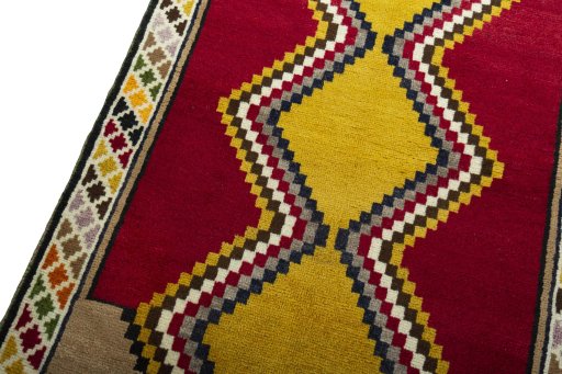 Backside of handmade 2000s Persian Gabbeh rug showing knot structure and weave density