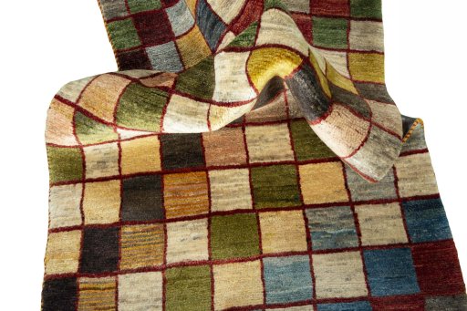 Corner detail of 2000s Persian Gabbeh rug showing border pattern and Wool pile