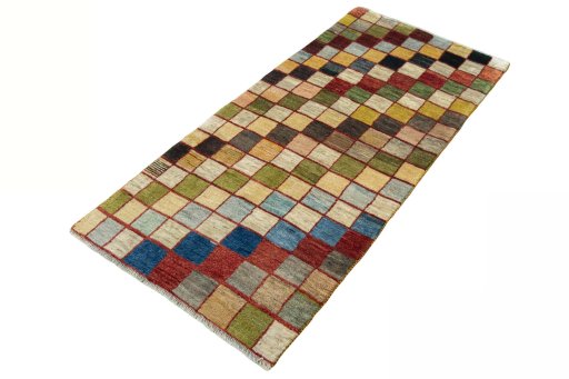 Corner detail of 2000s Persian Gabbeh rug showing border pattern and Wool pile
