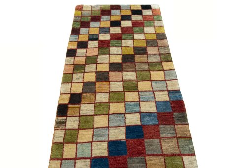 Surface texture of 2000s Persian Gabbeh rug with natural Wool and intricate pattern