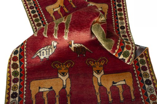 Corner detail of 2000s Persian Gabbeh rug showing border pattern and Wool pile