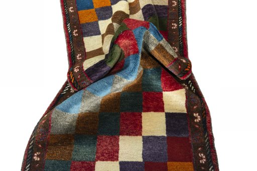 Corner detail of 2000s Persian Gabbeh rug showing border pattern and Wool pile
