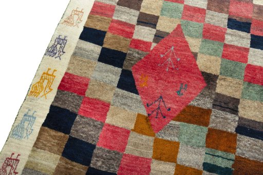 Backside of handmade 2000s Persian Gabbeh rug showing knot structure and weave density