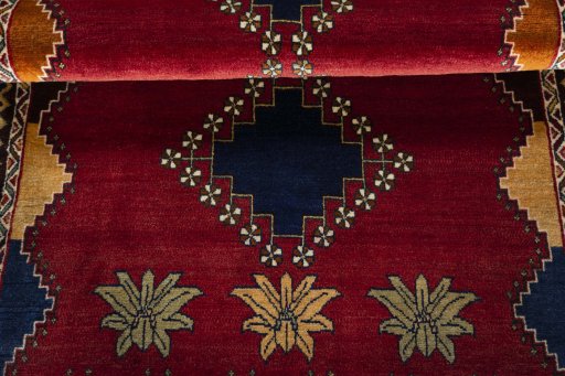 Full view of 2000s Persian Gabbeh rug from Iran / Persia, 182 × 112 cm in Red tones