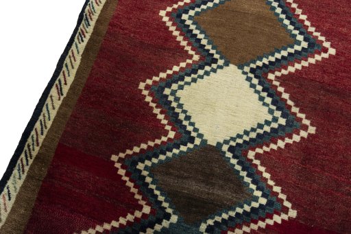 Backside of handmade 2000s Persian Gabbeh rug showing knot structure and weave density