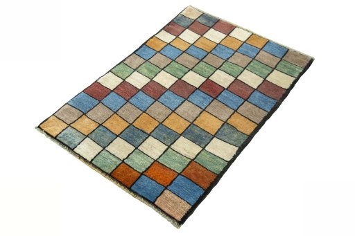 Corner detail of 2000s Persian Gabbeh rug showing border pattern and Wool pile