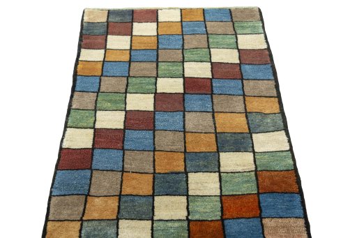 Surface texture of 2000s Persian Gabbeh rug with natural Wool and intricate pattern