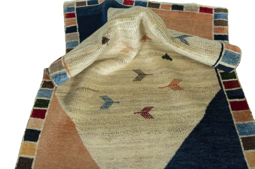 Corner detail of 2000s Persian Gabbeh rug showing border pattern and Wool pile