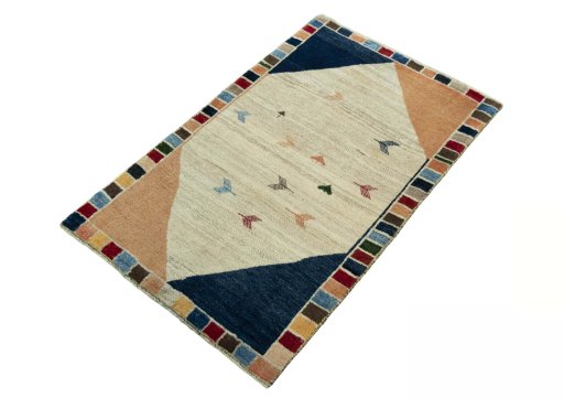 Corner detail of 2000s Persian Gabbeh rug showing border pattern and Wool pile