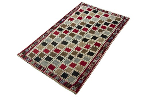 Corner detail of 2000s Persian Gabbeh rug showing border pattern and Wool pile