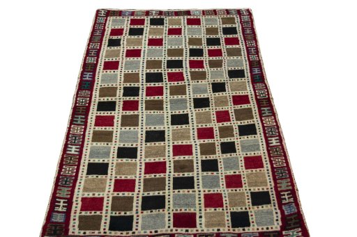 Surface texture of 2000s Persian Gabbeh rug with natural Wool and intricate pattern