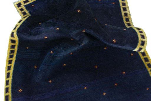 Corner detail of 2000s Persian Gabbeh rug showing border pattern and Wool pile