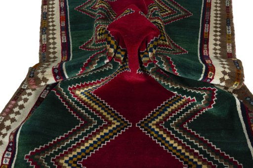 Corner detail of 2000s Persian Gabbeh rug showing border pattern and Wool pile