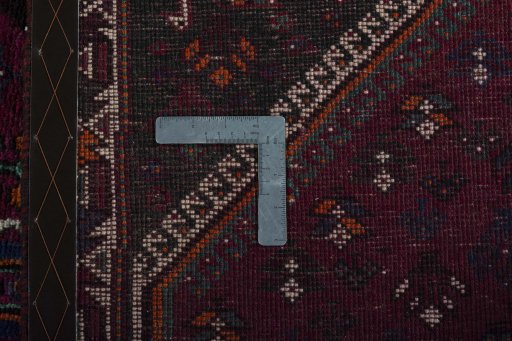 Surface texture of 2000s Persian Gabbeh rug with natural Wool and intricate pattern