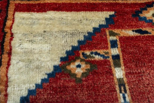 Surface texture of 1950s Persian Gabbeh rug with natural Wool and intricate pattern