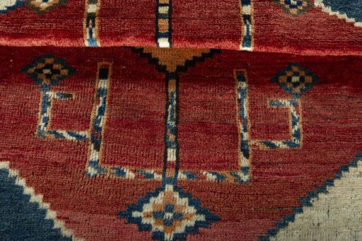 Full view of 1950s Persian Gabbeh rug from Iran / Persia, 112 × 96 cm in Red tones