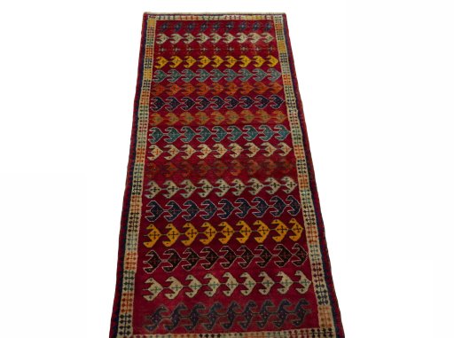 Surface texture of 2000s Persian Gabbeh rug with natural Wool and intricate pattern
