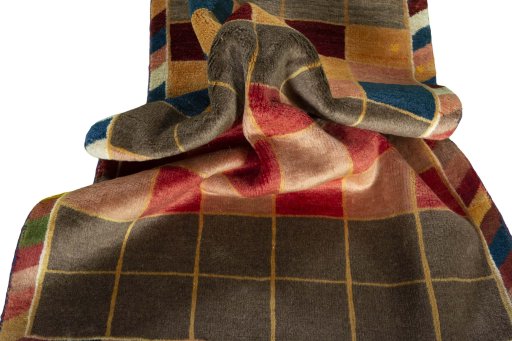 Corner detail of 2000s Persian Gabbeh rug showing border pattern and Wool pile