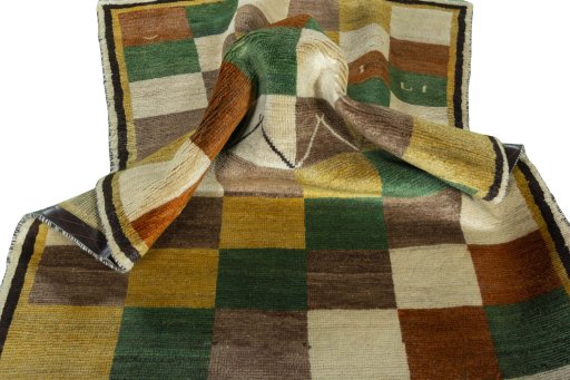 Corner detail of 2000s Persian Gabbeh rug showing border pattern and Wool pile